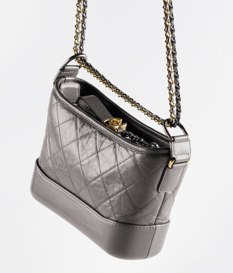 Chanel's Gabrielle Small Hobo Bag — Aged calfskin, smooth calfskin, gold-tone, silver-tone & ruthenium-finish metal — A91810Y61477NI691
